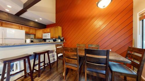 a kitchen with a table and chairs in a room at Bigwood #63 condo in Mammoth Lakes