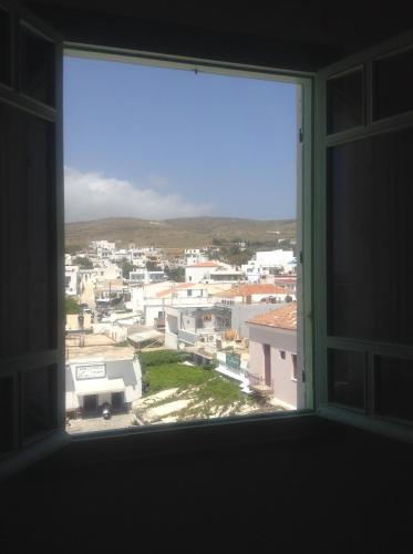 an open window with a view of a city at Aegli 1876 in Tinos Town