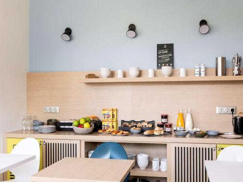 a kitchen with a counter with food on it at Appart'hotel Vacancéole Paris Quai de Marne in Nogent-sur-Marne