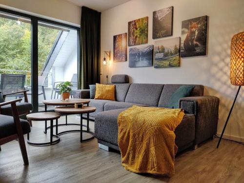 a living room with a couch and a table at Elpe Apartments Hochsauerland in Elpe