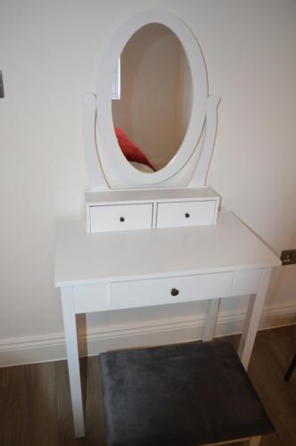 a white dressing table with a round mirror on it at Hatfield Gem - 1 Bed with FREE Parking near Uni, Business Park & City Center, Big savings on Longer Stays in Hatfield