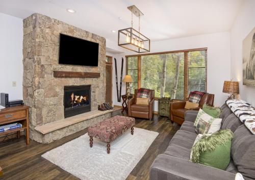 a living room with a couch and a fireplace at Aspenwood #207 Condo in Edwards