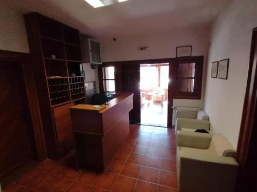 a living room with a desk and chairs in a room at MON Accommodation free parking in Niš