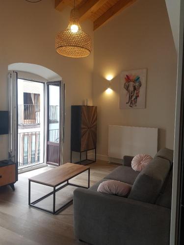 a living room with a couch and a table at La Rua 25 in Castro-Urdiales