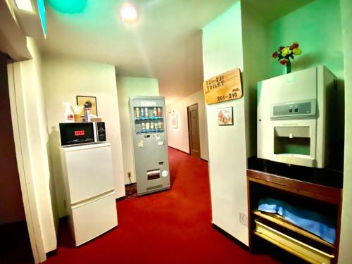 a room with a refrigerator and a microwave at Naeba Lodge Oka in Yuzawa