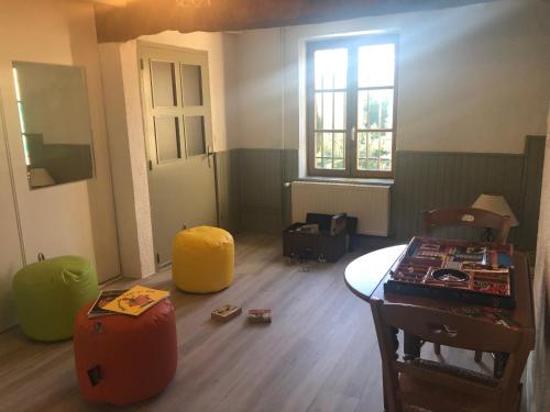 an empty room with a room with a table and chairs at Havre de paix et de verdure proche Walibi et A43 - 4 étoiles in Corbelin