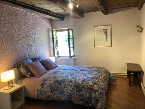 a bedroom with a bed and a window at Havre de paix et de verdure proche Walibi et A43 - 4 étoiles in Corbelin