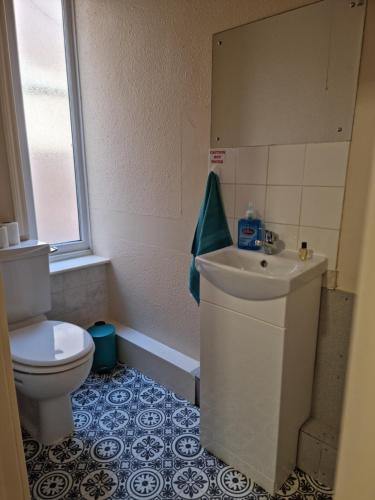 a bathroom with a toilet and a sink at The Regency Hotel in Blackpool