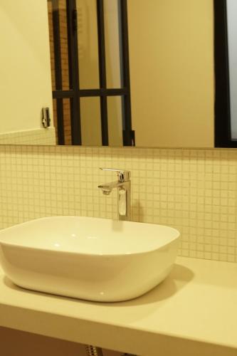 a white sink on a counter in a bathroom at D and D hotel in Tbilisi City