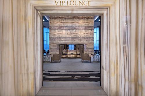 a view through a doorway into a lobby with chairs at Granada Luxury Belek - Family Kids Concept in Belek