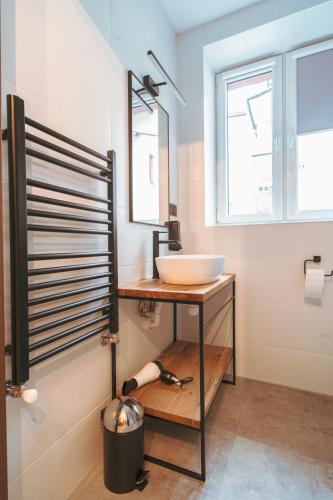 a bathroom with a sink and a mirror at Pokoje Venezia in Cieszyn