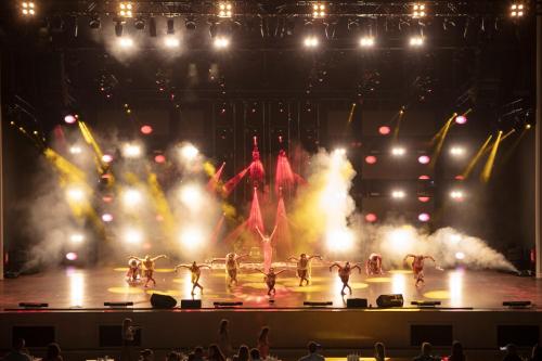 a group of dancers on a stage with lights at Granada Luxury Belek - Family Kids Concept in Belek