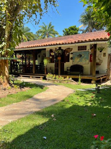 a house with a porch and a driveway at Pousada Horizonte Azul in Ilha de Boipeba