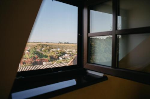 an open window with a view of a field at Джерело in Kamianets-Podilskyi
