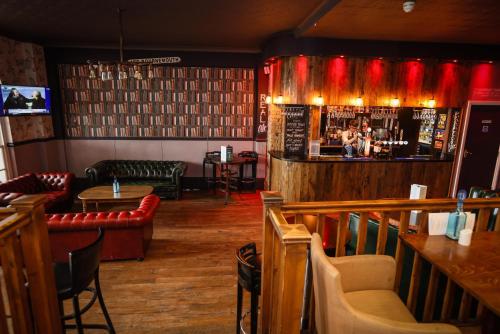 a restaurant with a bar with red lights at Suncliff Hotel - OCEANA COLLECTION in Bournemouth