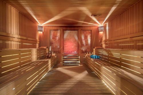 a hallway with wooden benches in a building at Granada Luxury Belek - Family Kids Concept in Belek
