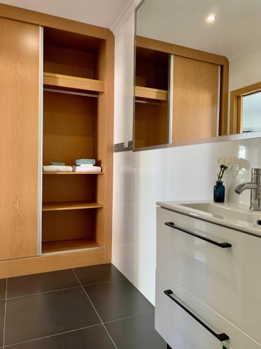 a bathroom with a sink and a counter top at BF Suites & Apartments in Porto