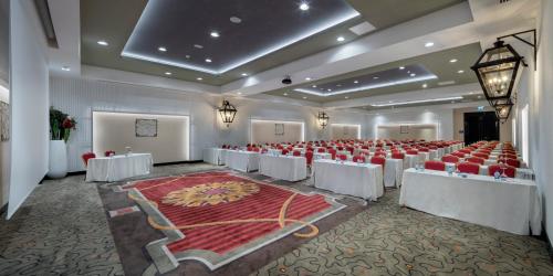 a large banquet hall with red chairs and tables at Granada Luxury Belek - Family Kids Concept in Belek