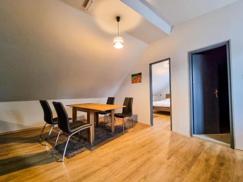 a dining room with a table and chairs at XXL Rooms Osijek in Osijek