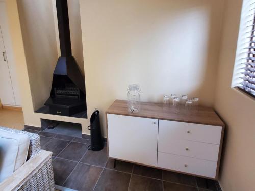 a room with a white cabinet and a stove at Avonlea Guesthouse in Polokwane