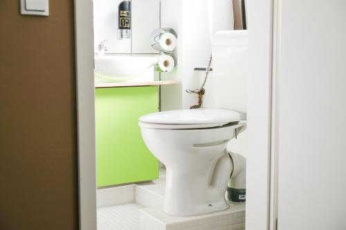a bathroom with a white toilet and a sink at Hammerbrook Hostel in Hamburg