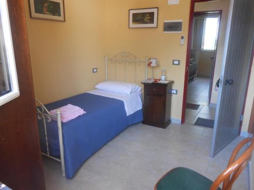 a small bedroom with a bed and a table at Agriturismo Eolo in Taranto