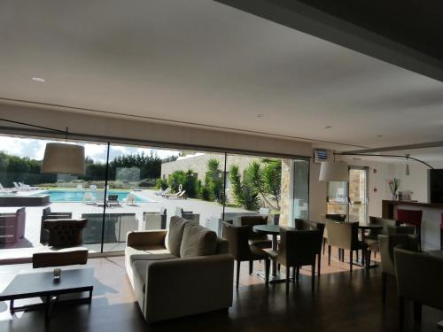 a living room with a couch and chairs and a table at Hotel Vila D'Óbidos in Óbidos