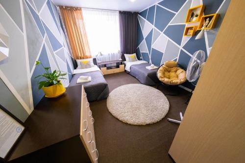 a small living room with a blue and white wall at Hotel Moonlight in Tula