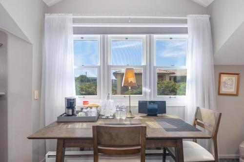 a dining room with a table and a window at Nantucket Whale Inn, Half Moon Bay in Half Moon Bay