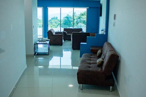 a living room with couches and a couch and a table at LA LOMA SUITES in Ixtapa