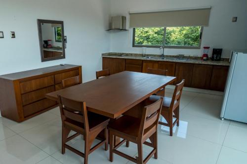 a kitchen with a large wooden table and chairs at LA LOMA SUITES in Ixtapa