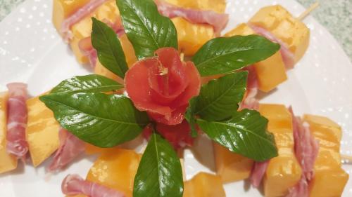 a plate of food with a red rose on it at Residence Alberghiero Eolie in Lipari