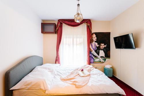 a bedroom with a bed and a window at Petra Inn Apartments in historical palace Bratislava in Bratislava