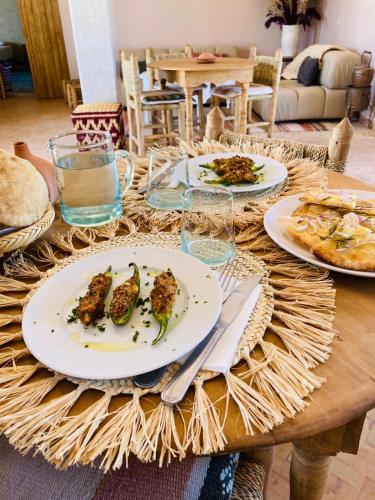 a wooden table with plates of food on it at Upupa de l’Atlas in Marrakech