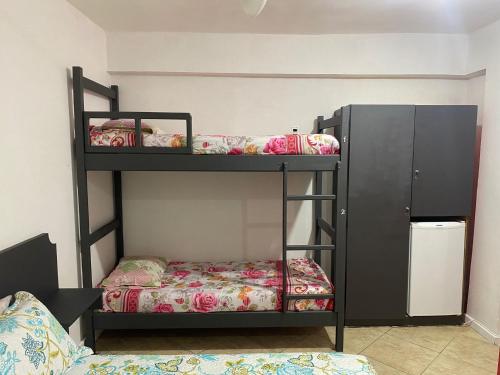 a bunk bed room with two bunk beds at Ipanema Club Hostel in Rio de Janeiro