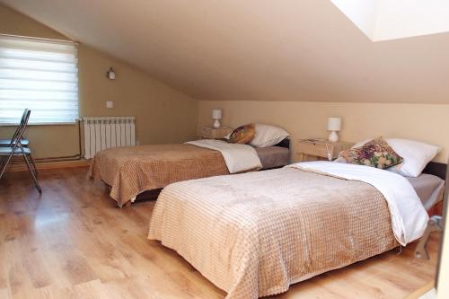 a bedroom with two beds and a window at Agroturystka u Basi in Pietrzykowice