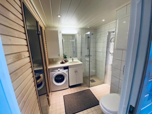 a bathroom with a washing machine and a washer at Pellestova Apartments in Hafjell