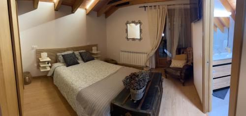 a bedroom with a bed and a chair and a mirror at Los Toriles in Los Espejos de la Reina