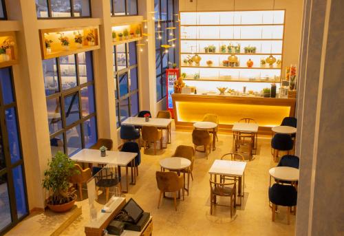 an overhead view of a restaurant with tables and chairs at VANCII Hotel in Chefchaouene