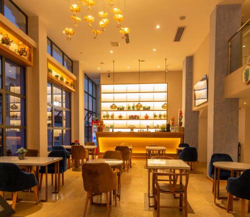 a restaurant with tables and chairs and a counter at VANCII Hotel in Chefchaouene