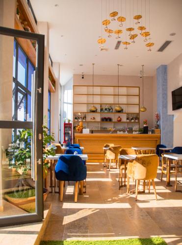 a restaurant with tables and chairs and a dining room at VANCII Hotel in Chefchaouene