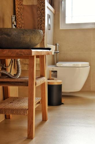 a bathroom with a sink and a bath tub at Angelos Design Suites in Patitiri
