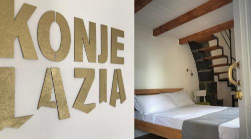 a bedroom with a bed and a sign that reads one avenueza at Konjelazia - Tourism & Design in Gyumri