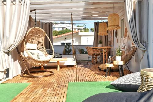 a porch with chairs and a table on a balcony at Angelos Design Suites in Patitiri