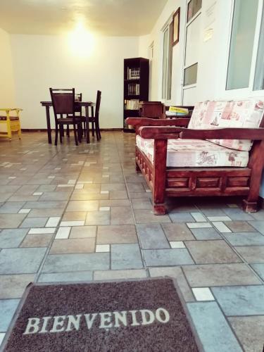a living room with furniture and a rug on the floor at Hostal Maple in Querétaro