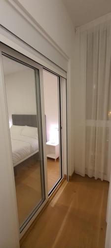 a room with a sliding glass door leading to a bedroom at APARTAMENTO FRANJA 50 Gastromaar in A Coruña