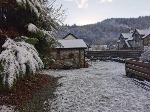 a house with snow on the ground in front of it at Dolweunydd Bed and Breakfast in Betws-y-coed
