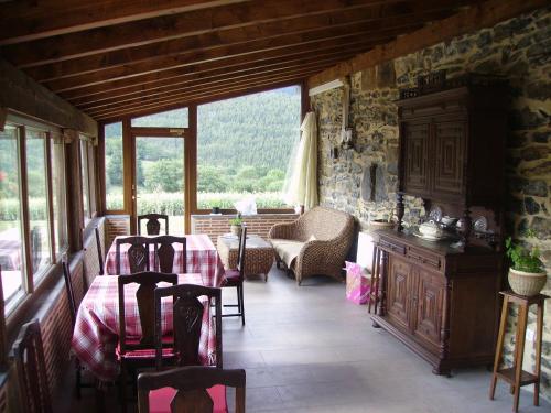 a dining room with a table and chairs in a building at Casa Rural Pikatzaenea in Sopuerta