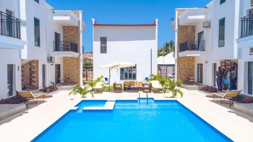 a pool in the courtyard of a villa at Mica Apartments in Sere Kunda