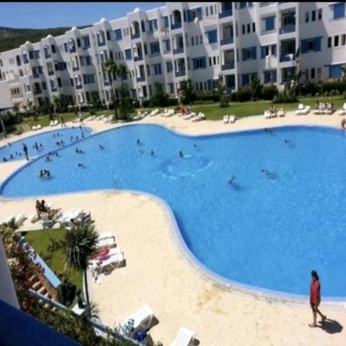 a large swimming pool in front of a large apartment building at Apartamento Marina Smir in Tetouan